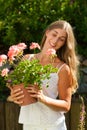 Garden in summer Ã¢â¬â happy woman with flowers